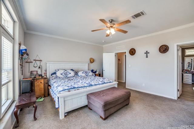 bedroom with baseboards, visible vents, carpet floors, and ornamental molding