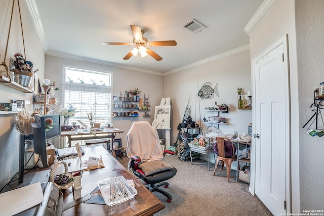 office space with crown molding, carpet flooring, a ceiling fan, and visible vents