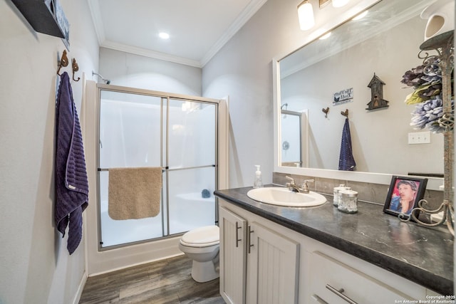 full bath with vanity, wood finished floors, an enclosed shower, crown molding, and toilet