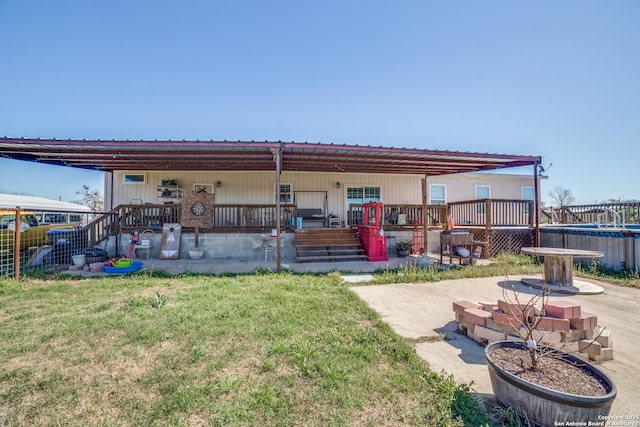 rear view of house featuring metal roof and a yard