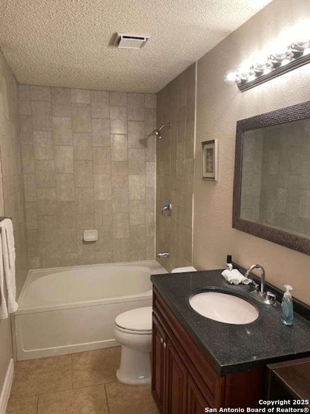 bathroom with toilet, a textured ceiling, washtub / shower combination, tile patterned flooring, and vanity