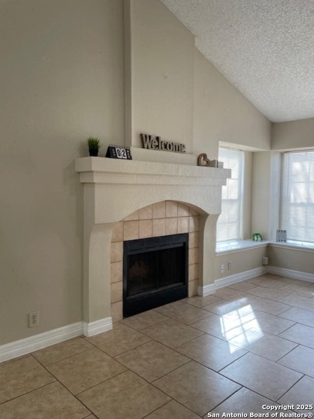 interior details featuring a fireplace, baseboards, and a textured ceiling