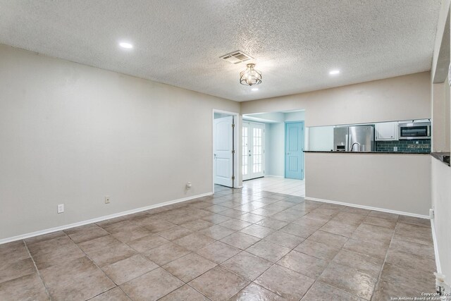 5918 Oak Country Way, San Antonio, TX 78247 - unfurnished living room with a textured ceiling, visible vents, baseboards, recessed lighting, and light tile patterned floors