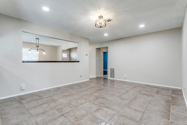 5918 Oak Country Way, San Antonio, TX 78247 - tiled empty room with recessed lighting, baseboards, a textured ceiling, visible vents, and a notable chandelier