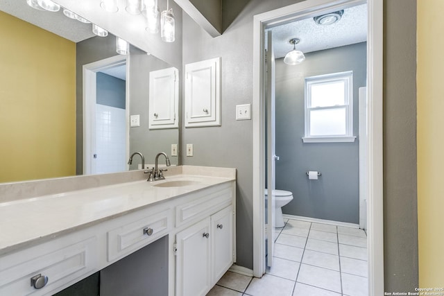 5918 Oak Country Way, San Antonio, TX 78247 - bathroom with a textured ceiling, baseboards, toilet, vanity, and tile patterned flooring