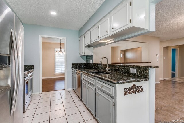 5918 Oak Country Way, San Antonio, TX 78247 - kitchen featuring a sink, white cabinetry, appliances with stainless steel finishes, a peninsula, and light tile patterned floors