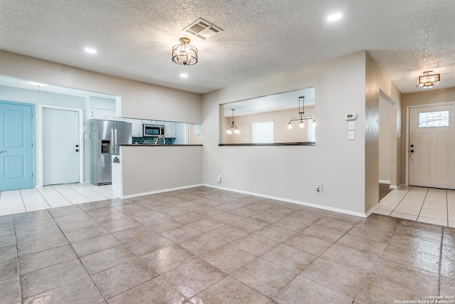 5918 Oak Country Way, San Antonio, TX 78247 - unfurnished living room featuring a textured ceiling, light tile patterned floors, baseboards, visible vents, and recessed lighting