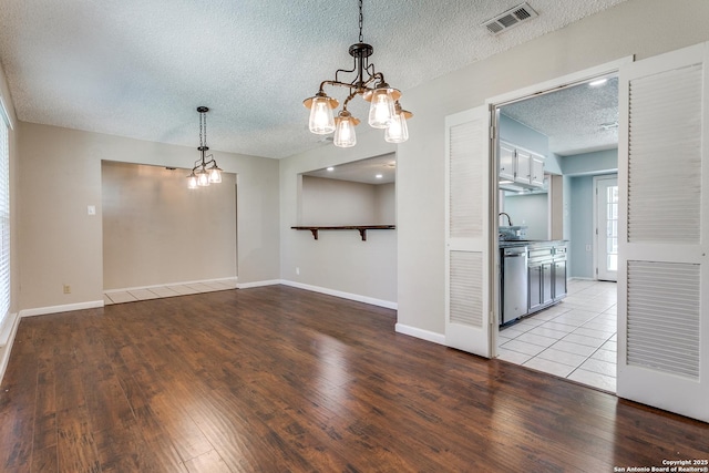 5918 Oak Country Way, San Antonio, TX 78247 - interior space with wood finished floors, a textured ceiling, baseboards, visible vents, and an inviting chandelier