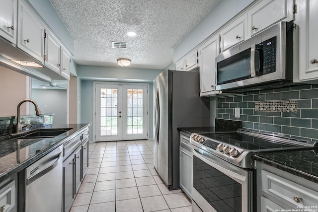5918 Oak Country Way, San Antonio, TX 78247 - kitchen featuring tasteful backsplash, appliances with stainless steel finishes, a sink, french doors, and light tile patterned floors