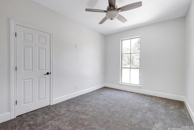 empty room with baseboards, ceiling fan, and carpet flooring