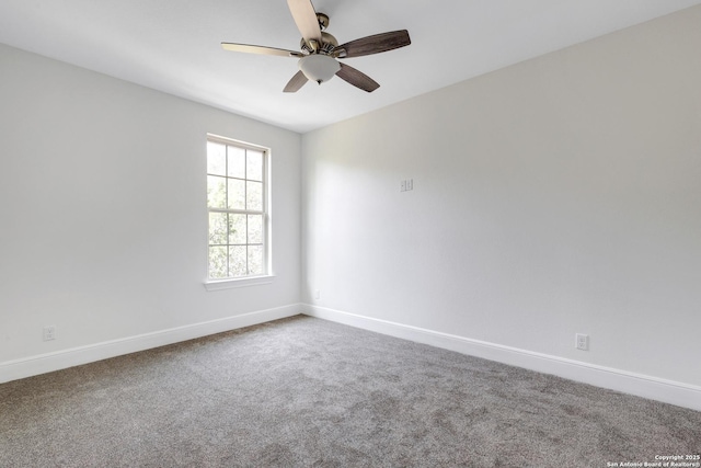 carpeted empty room featuring baseboards and ceiling fan