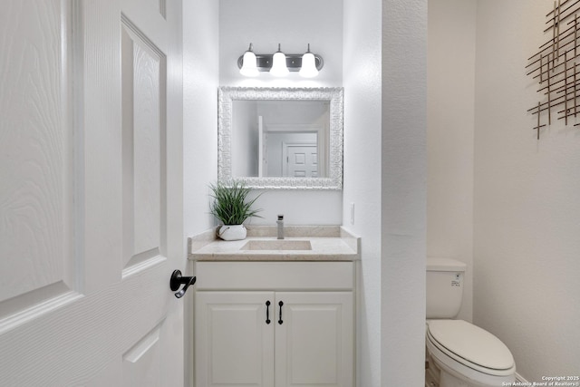 half bathroom featuring toilet and vanity