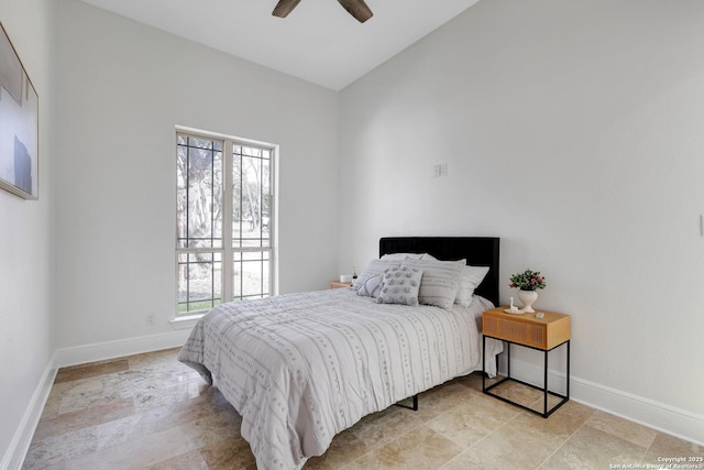 bedroom featuring ceiling fan, baseboards, and vaulted ceiling