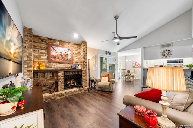 living room with wood finished floors, visible vents, high vaulted ceiling, ceiling fan, and a brick fireplace