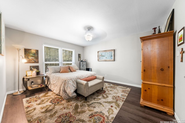 bedroom featuring baseboards and wood finished floors