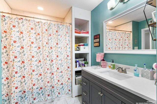 bathroom featuring vanity, a shower with curtain, and built in shelves