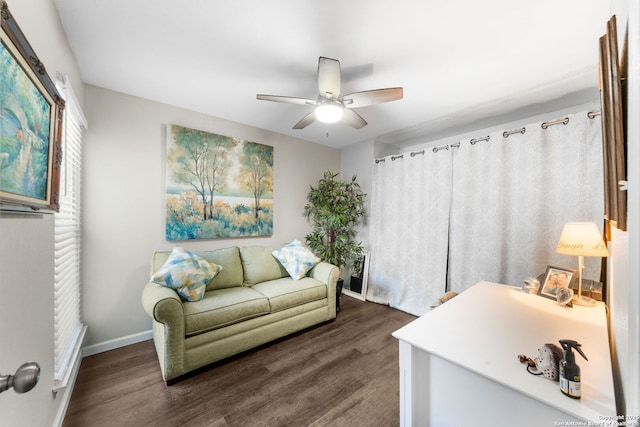 living room with baseboards, a ceiling fan, and wood finished floors