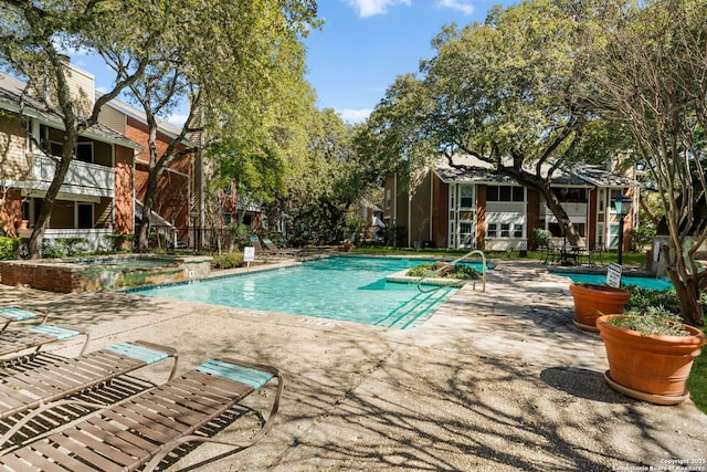 pool featuring a patio and a hot tub