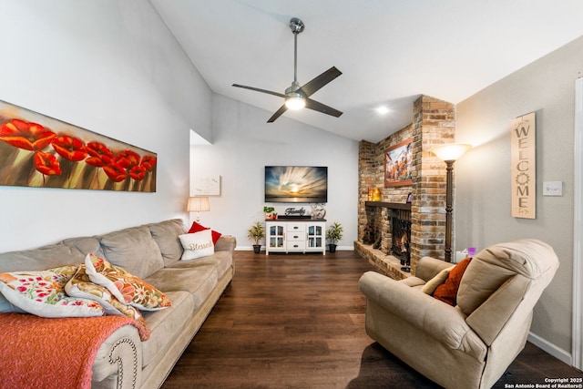 living area with baseboards, vaulted ceiling, a fireplace, wood finished floors, and a ceiling fan