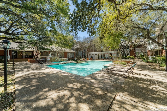 community pool featuring a patio area