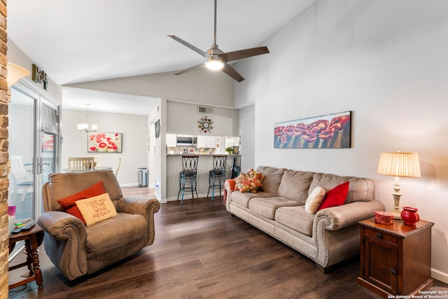 living area with ceiling fan with notable chandelier, dark wood-style floors, visible vents, and baseboards