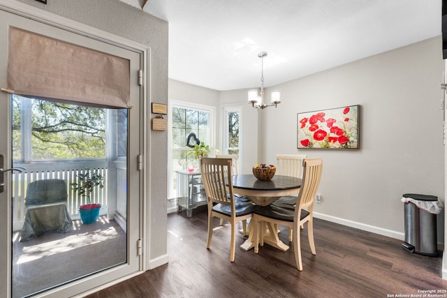 dining space featuring an inviting chandelier, baseboards, and dark wood-style flooring