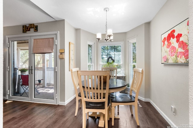 dining space featuring dark wood finished floors, a healthy amount of sunlight, and baseboards