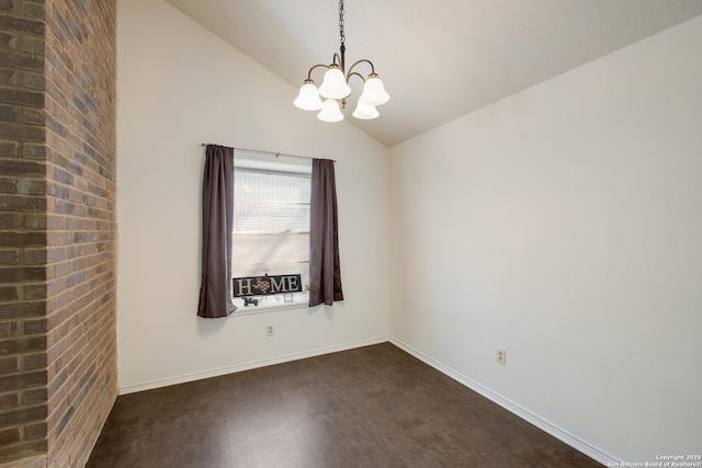 spare room with a chandelier, baseboards, lofted ceiling, and dark floors