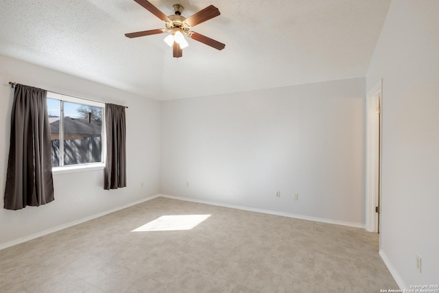 unfurnished room with ceiling fan, a textured ceiling, and baseboards