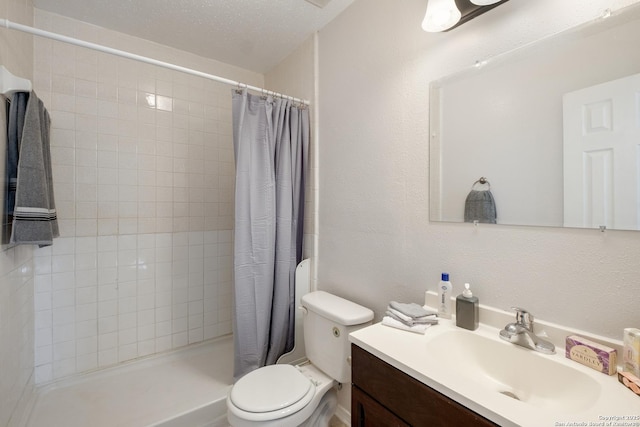 full bath featuring vanity, toilet, a shower stall, and a textured wall