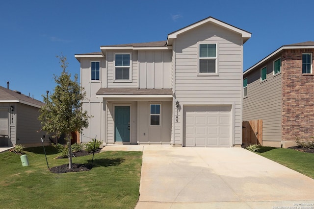 traditional-style home featuring board and batten siding, a front lawn, fence, driveway, and an attached garage