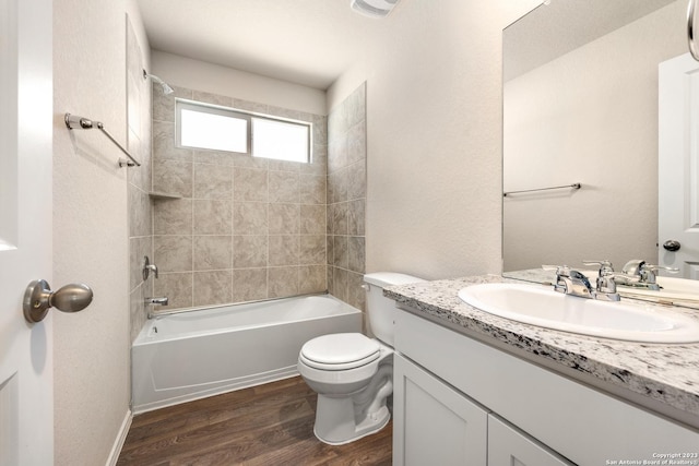 bathroom featuring vanity, wood finished floors, visible vents, shower / bath combination, and toilet