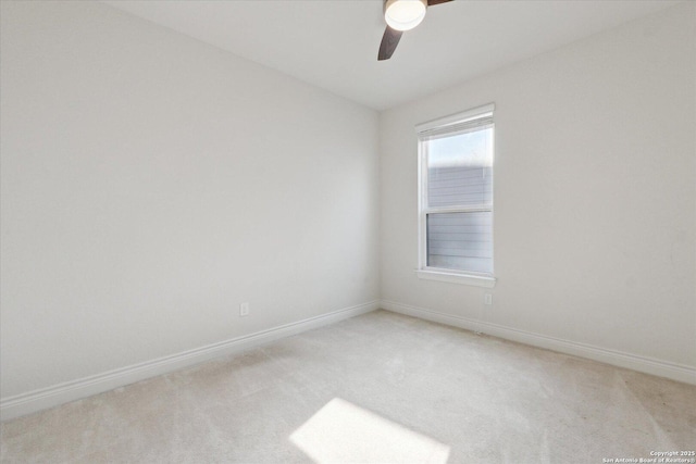 empty room featuring light carpet, ceiling fan, and baseboards