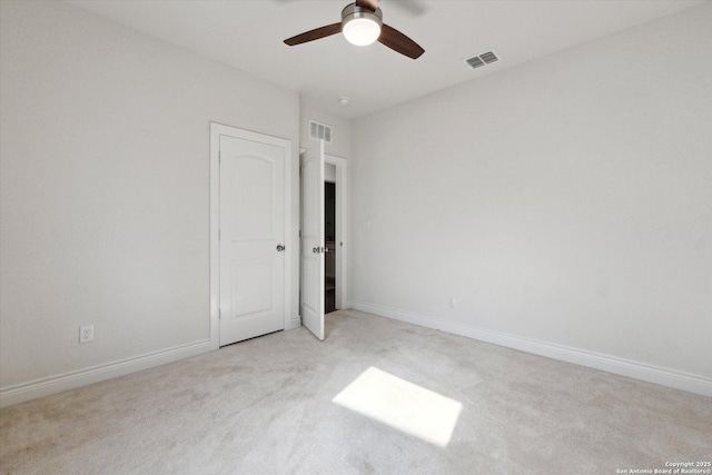 unfurnished bedroom featuring visible vents, carpet flooring, baseboards, and ceiling fan