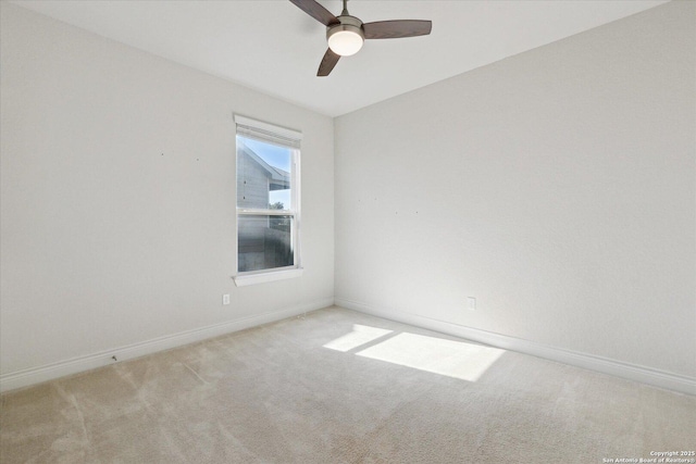 spare room featuring baseboards, ceiling fan, and carpet flooring