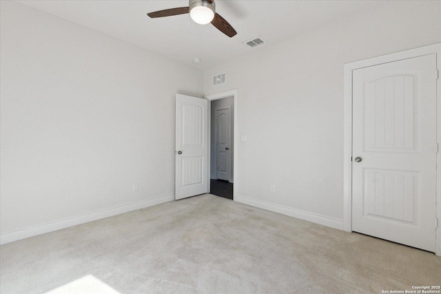 unfurnished bedroom featuring a ceiling fan, carpet flooring, baseboards, and visible vents