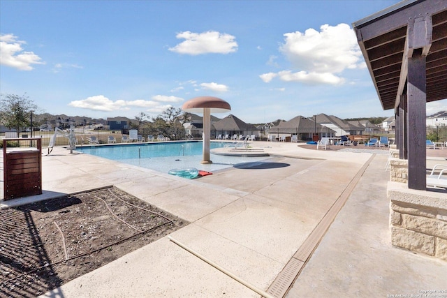 pool featuring a patio area and fence