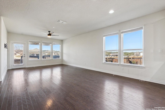 unfurnished room with dark wood-type flooring, baseboards, visible vents, and ceiling fan