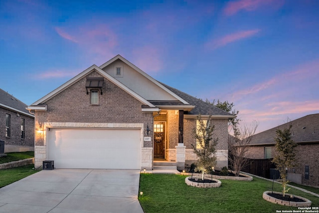 view of front facade with a garage, brick siding, concrete driveway, and a front yard