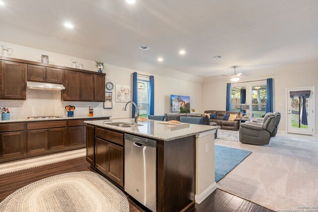 kitchen featuring visible vents, under cabinet range hood, dark brown cabinetry, appliances with stainless steel finishes, and a sink