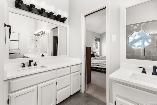 ensuite bathroom with two vanities, connected bathroom, and a sink