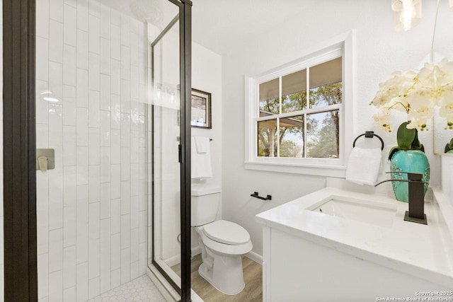 full bath with a shower stall, toilet, vanity, and baseboards