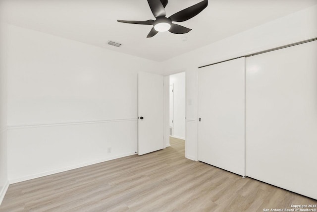 unfurnished bedroom with visible vents, baseboards, light wood-style floors, a closet, and a ceiling fan