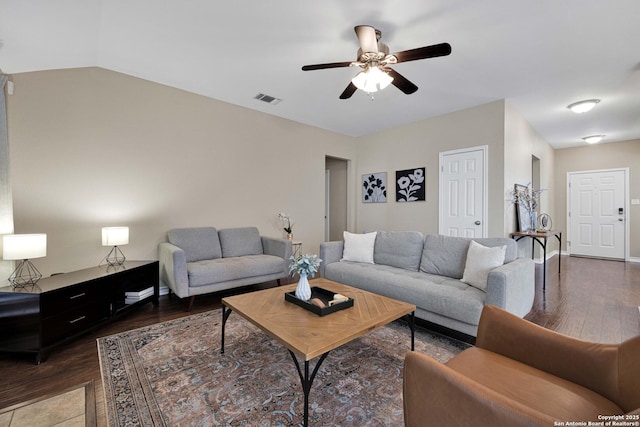 living area featuring visible vents, a ceiling fan, wood finished floors, baseboards, and lofted ceiling