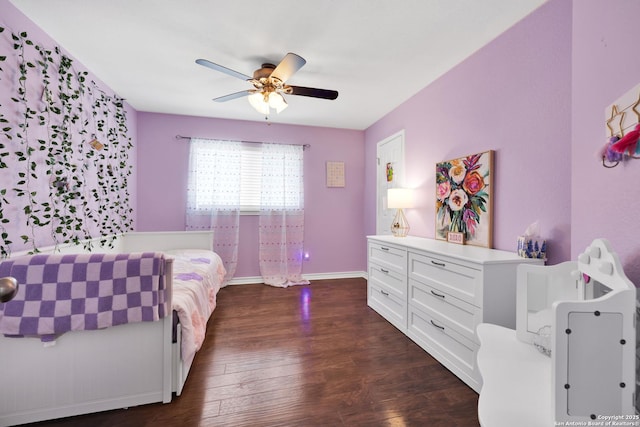 bedroom with dark wood-type flooring, a ceiling fan, and baseboards