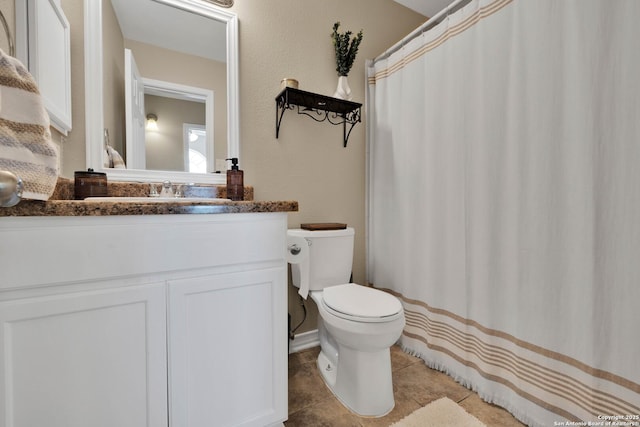 bathroom featuring tile patterned floors, toilet, and vanity