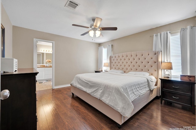 bedroom featuring visible vents, a ceiling fan, dark wood-style floors, connected bathroom, and baseboards