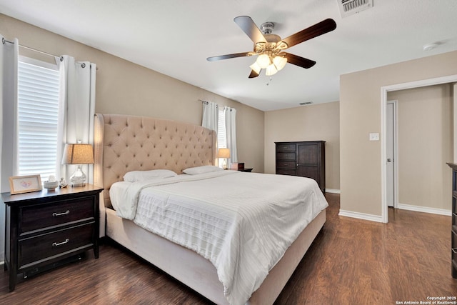 bedroom with dark wood finished floors, baseboards, visible vents, and ceiling fan