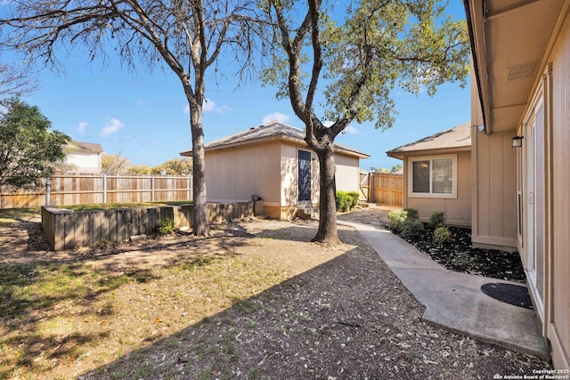 view of yard with an outdoor structure and a fenced backyard