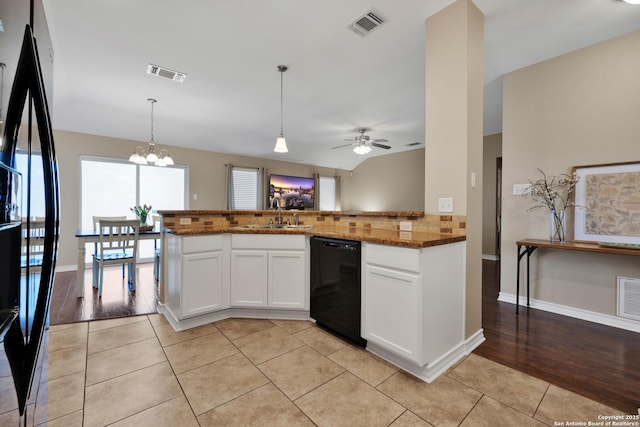 kitchen featuring light tile patterned floors, visible vents, black appliances, and a sink